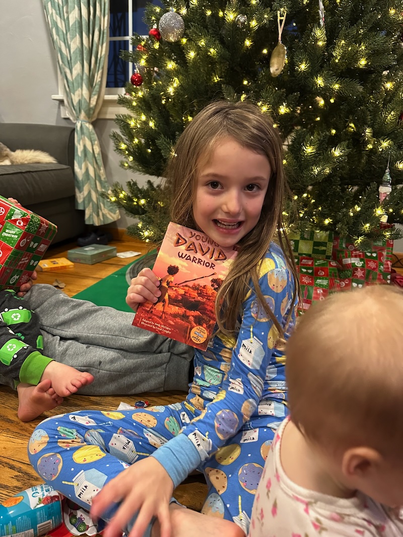 Girl holding up Young David book