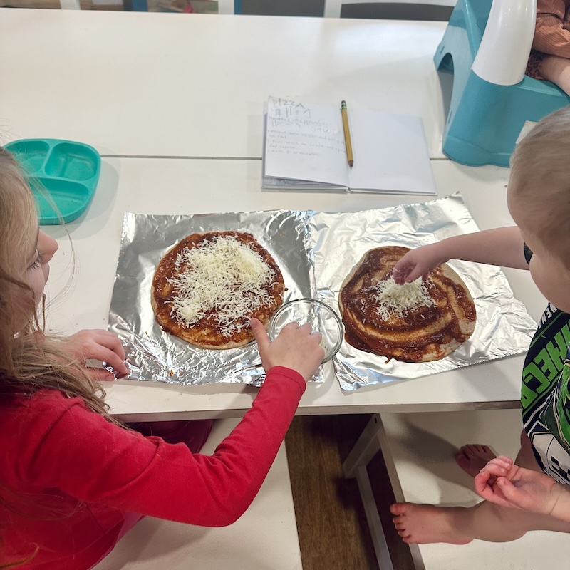 Kids making pizzas together