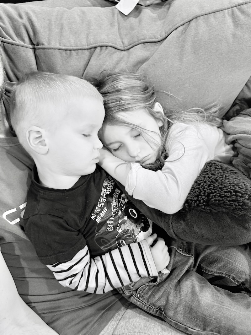 Kids sleeping together on couch