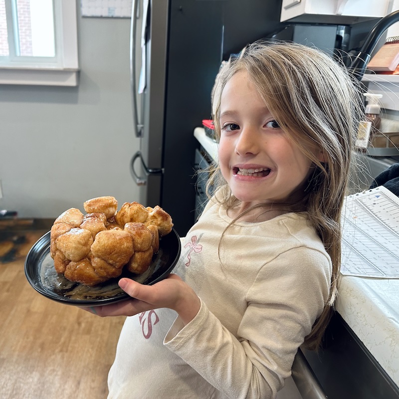 Girl holding plate of monkey bread