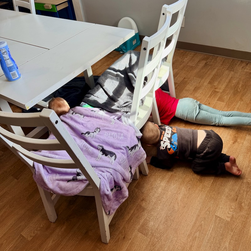 Kids playing under kitchen table
