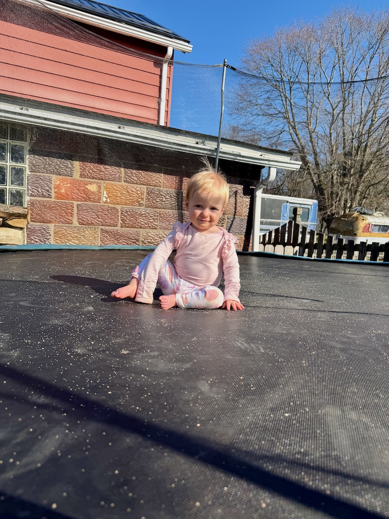 Baby girl on trampoline
