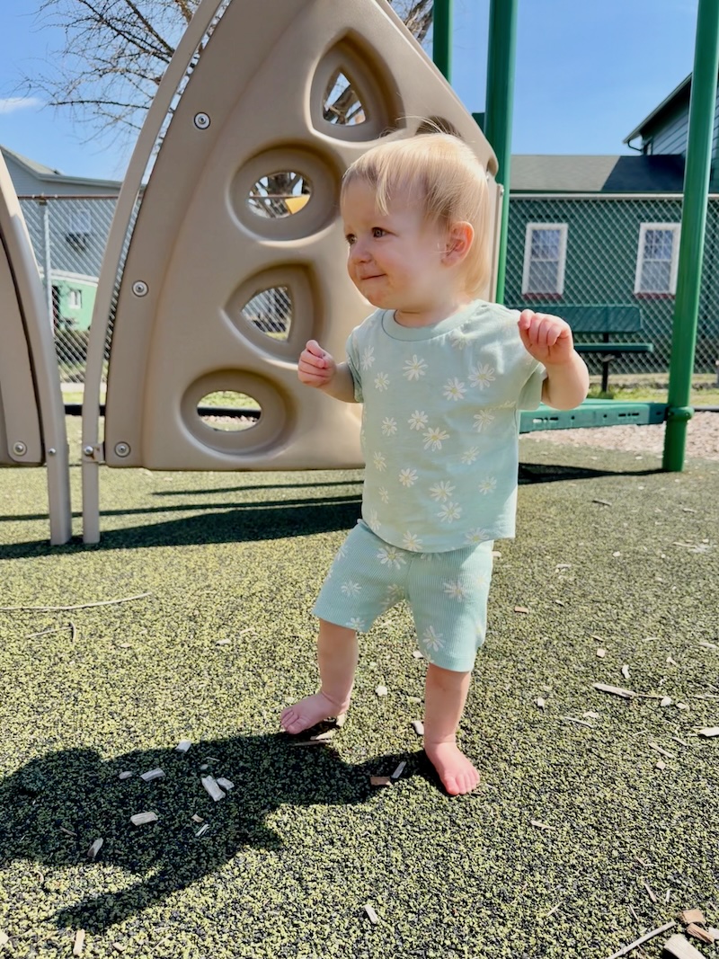 Baby girl walking at park