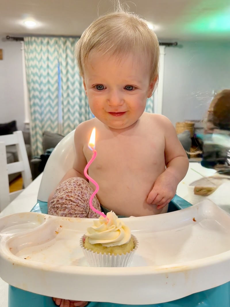 Baby girl with birthday cupcake