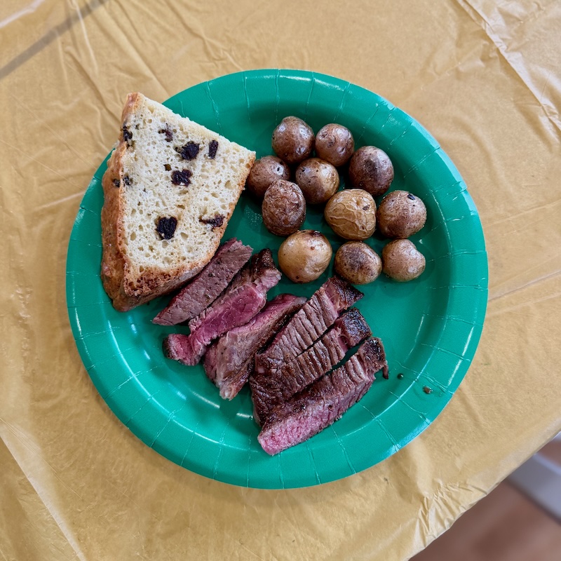 Lamb, potatoes, and Irish soda bread on a green plate