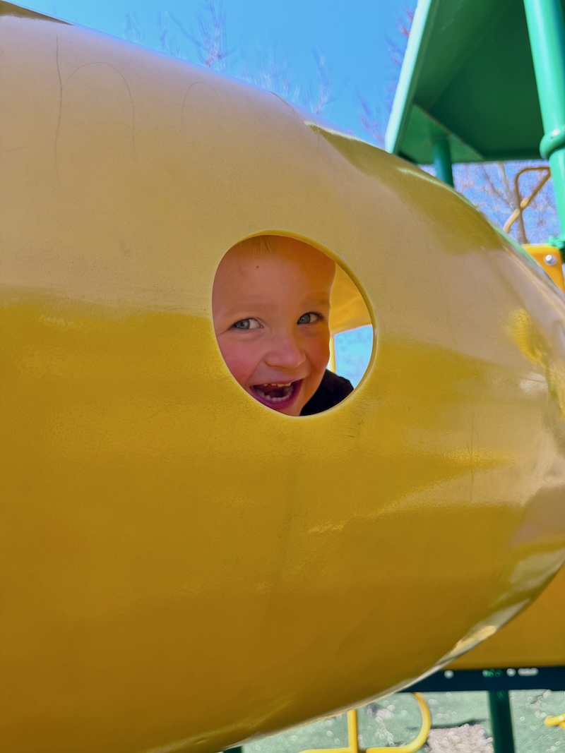 Boy in tunnel at park