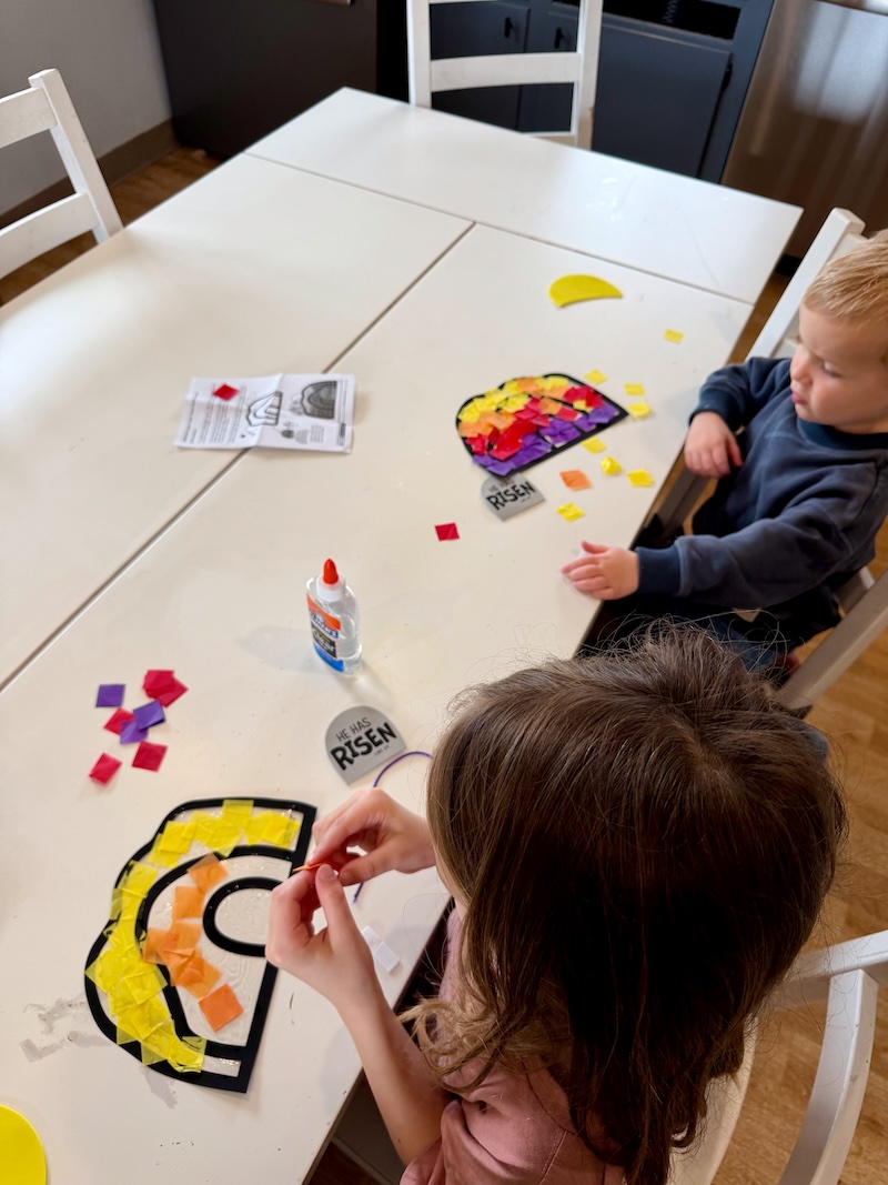 Kids sitting at kitchen table doing Easter crafts