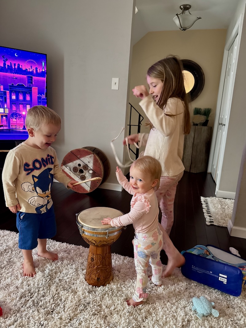 Three kids playing drum