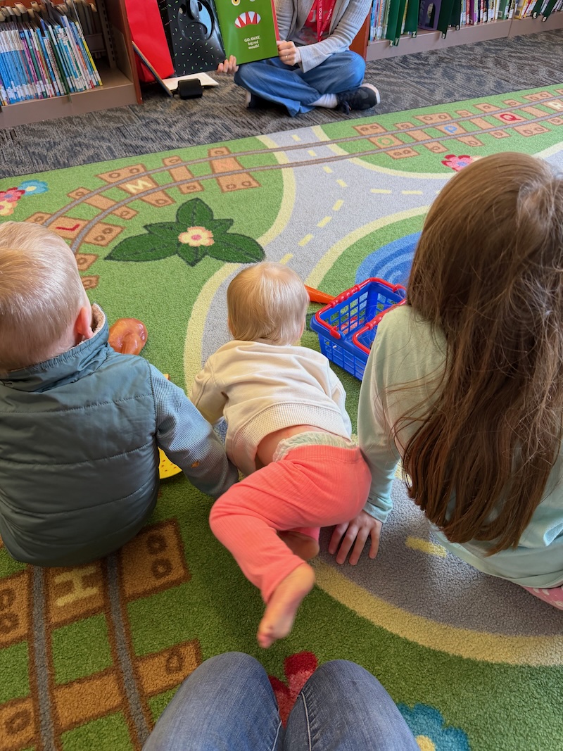 Kids sitting on rug in library