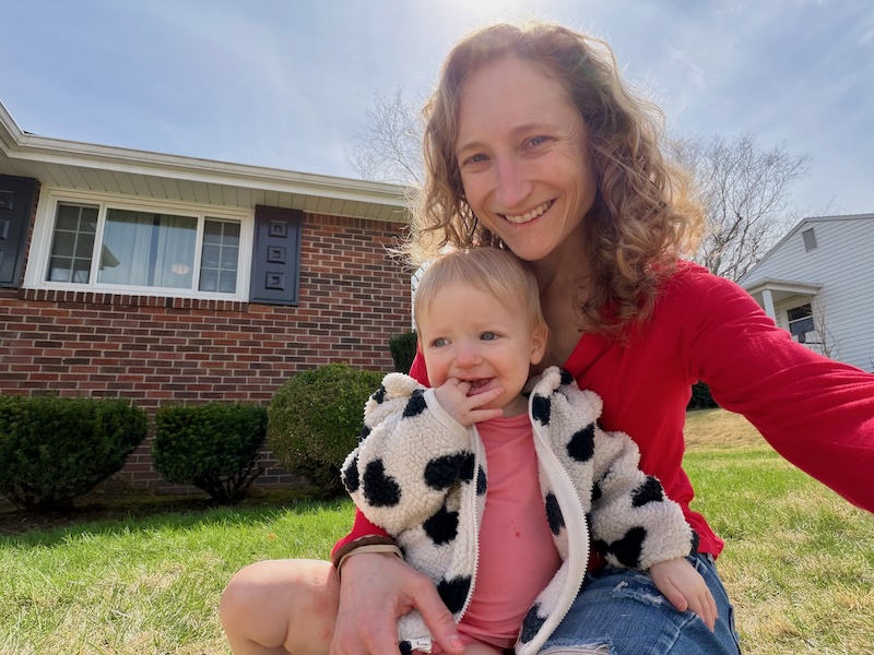 Mom sitting in grass with baby