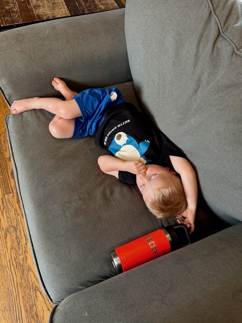 Toddler boy laying on the couch