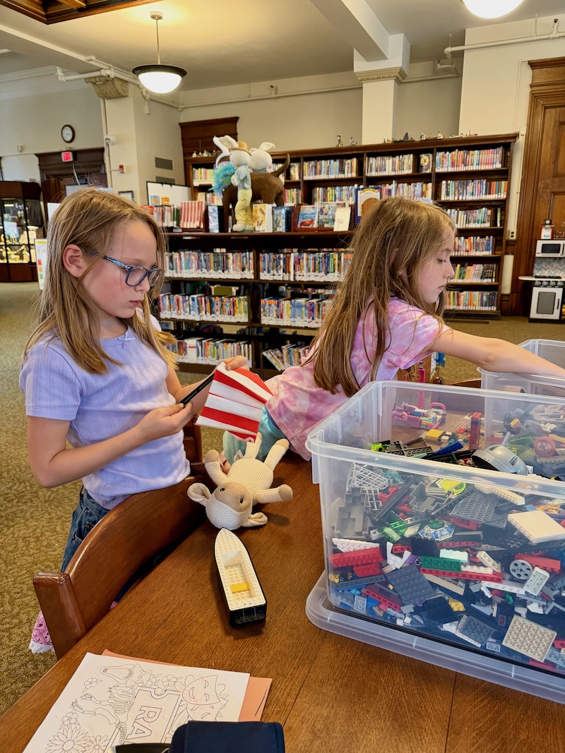 Girls playing with Lego at library