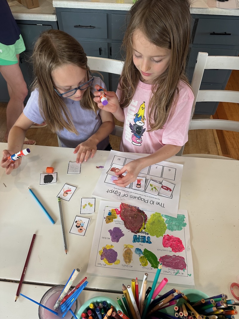 Girls doing ten plagues school activity