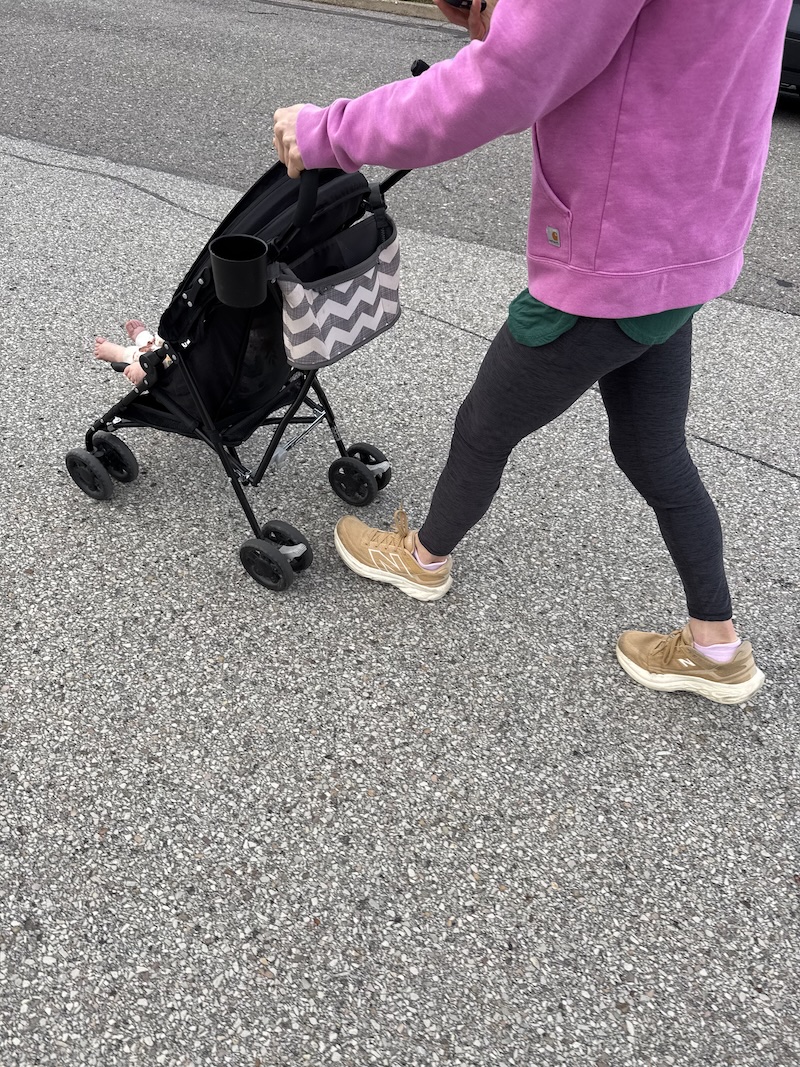 Girl pushing stroller