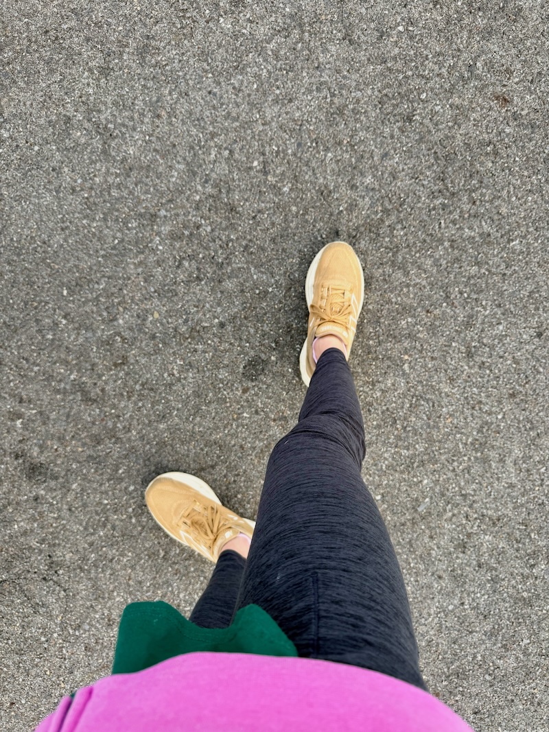 Girl standing on pavement with yellow shoes
