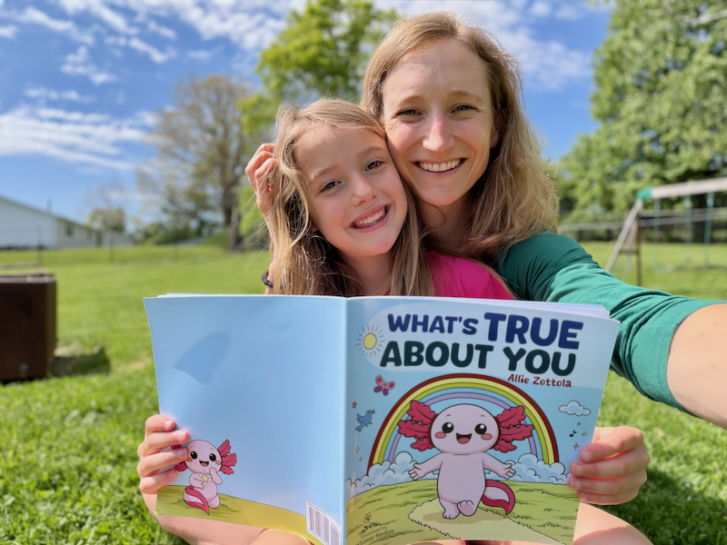 Mom and daughter with book What's True About You