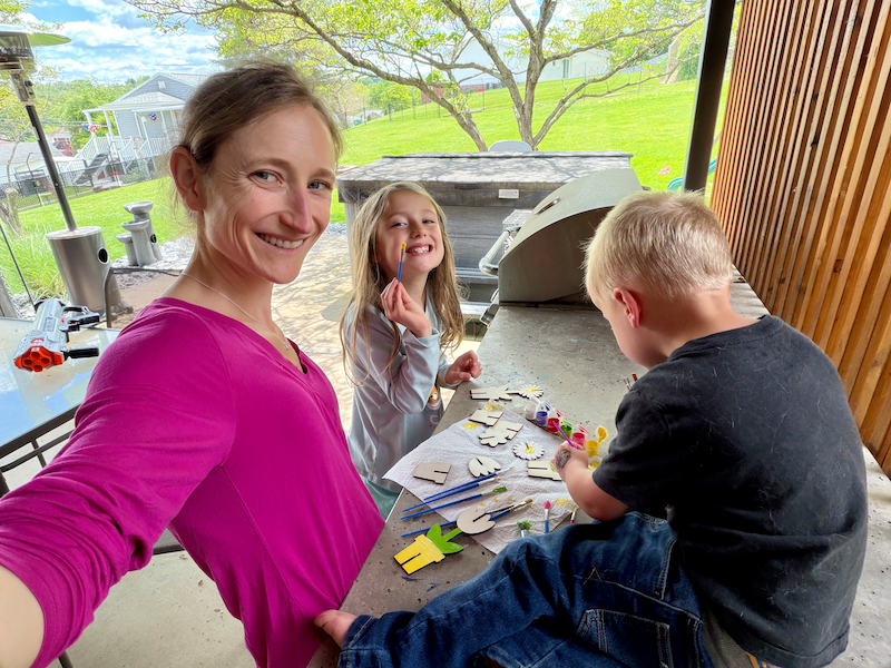 Mom and kids painting outside