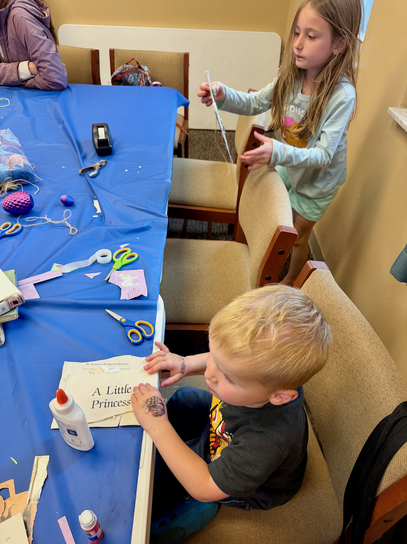 Brother and sister doing crafts at library