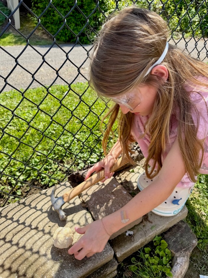 Girl breaking open geode