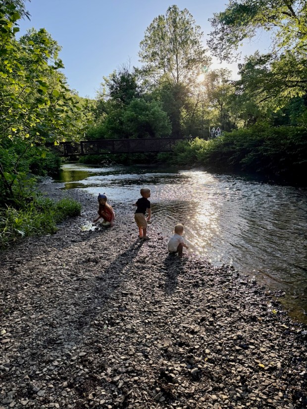 Kids playing by creek