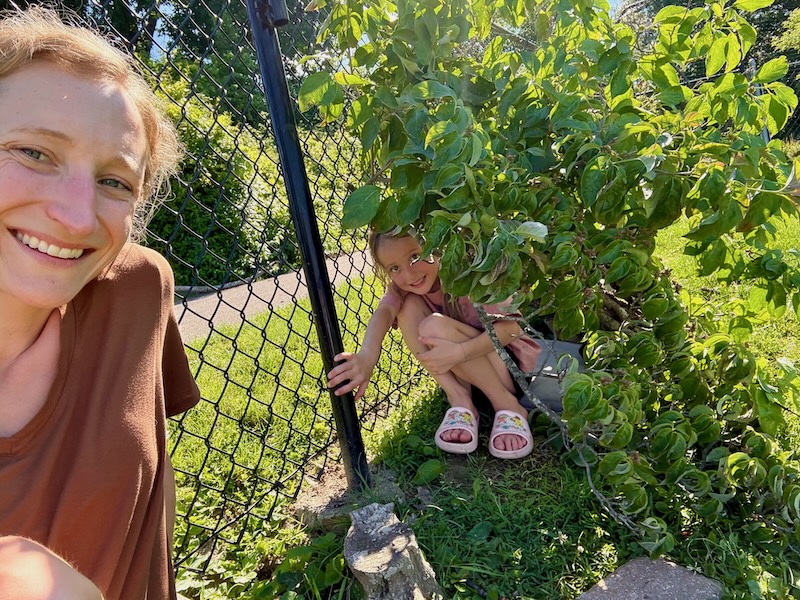Mom and daughter in backyard lean-to