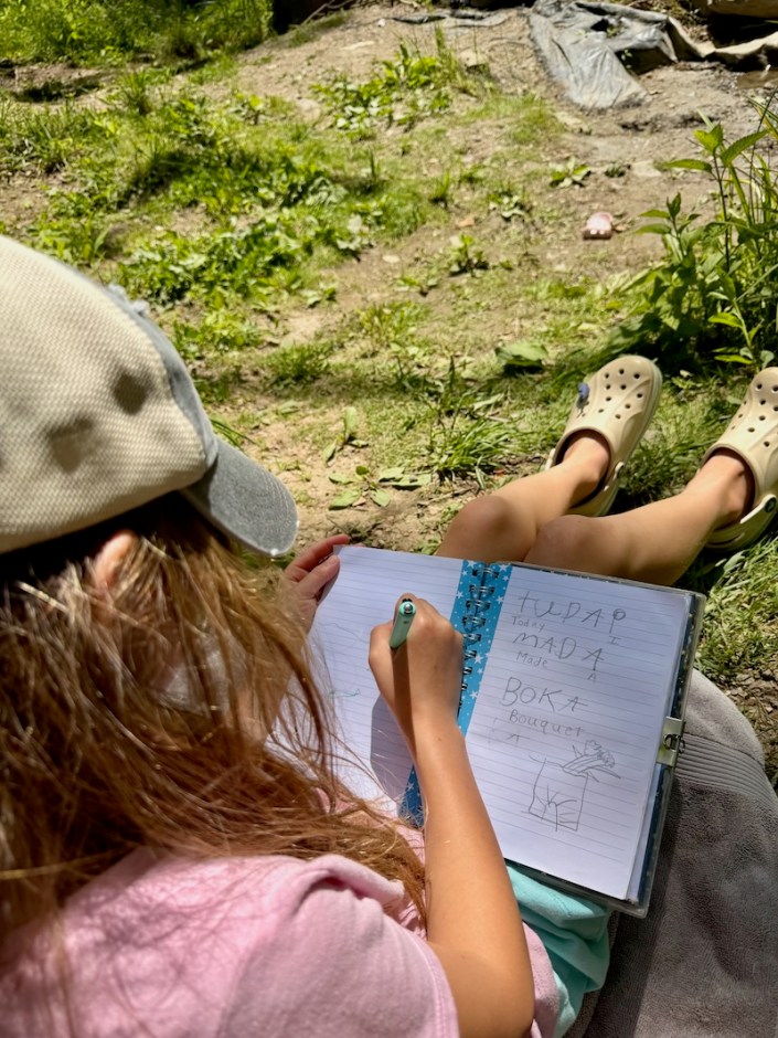 Girl writing outside