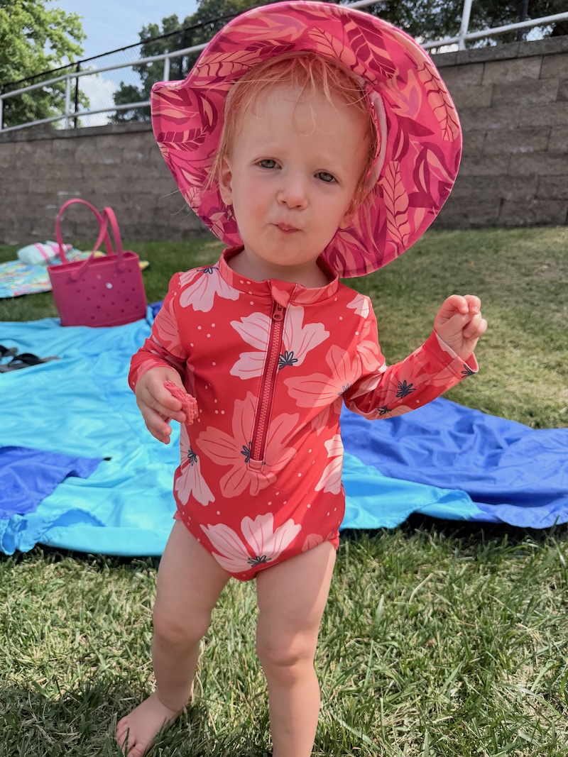 Baby girl wearing hat and bathing suit