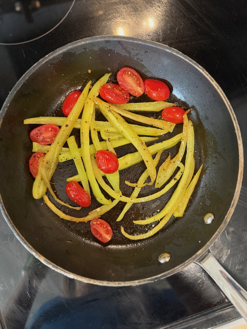 Banana pepper and tomato in skillet