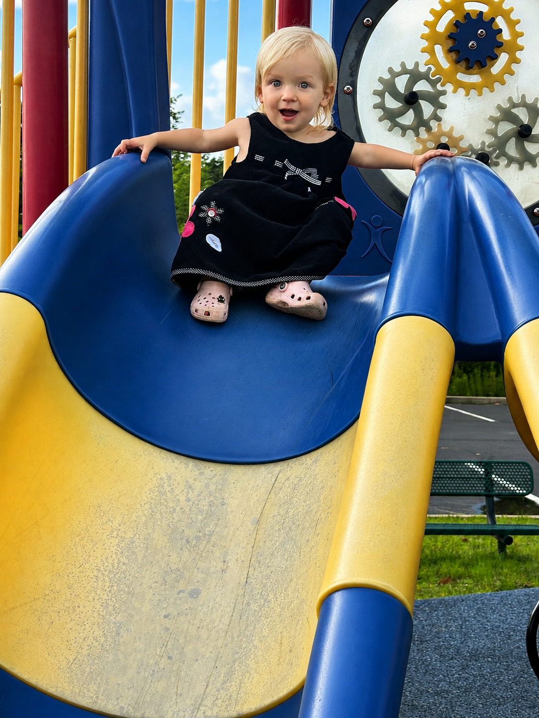 Toddler girl on slide at playground