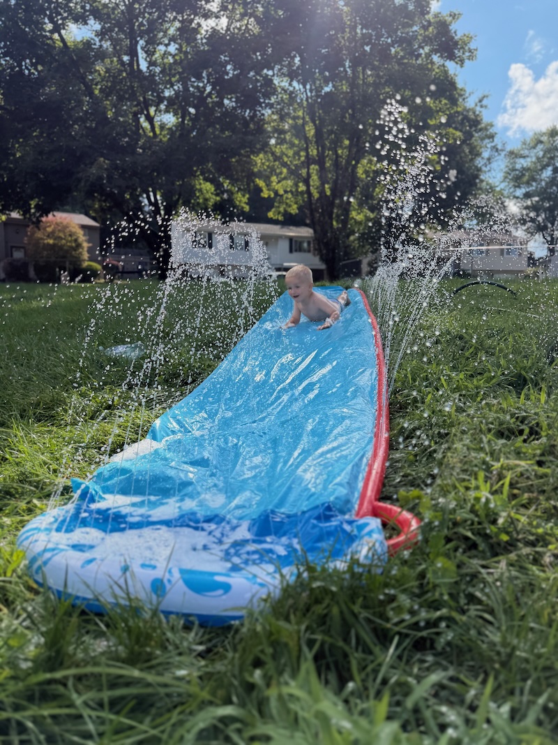 Toddler boy on slip n slide