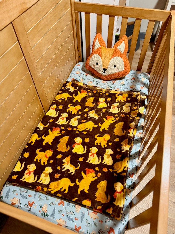 Fox pillow and fall blanket in crib