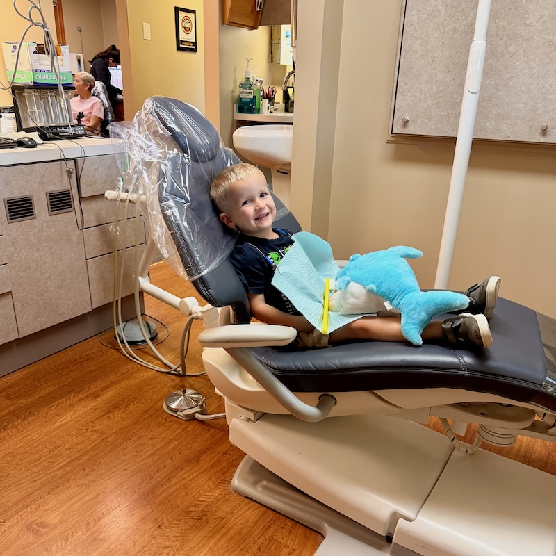 Toddler boy sitting in dental chair