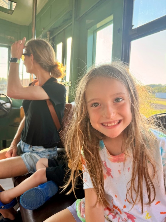 Girl smiling while riding a trolley