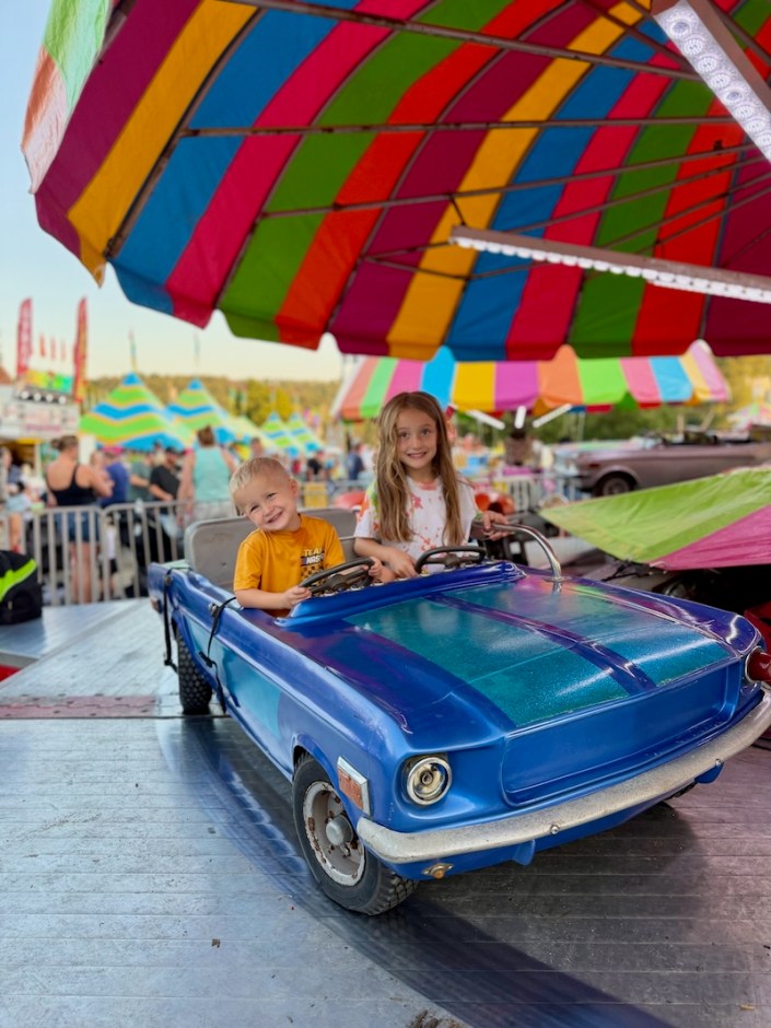 Kids riding a car ride at Washington County Fair