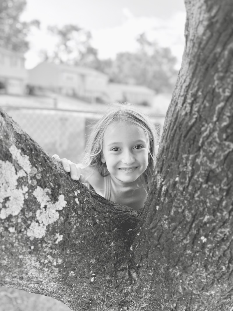 Girl smiling by tree