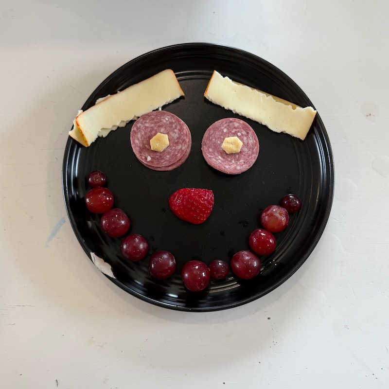 Food arranged into a smile on a plate
