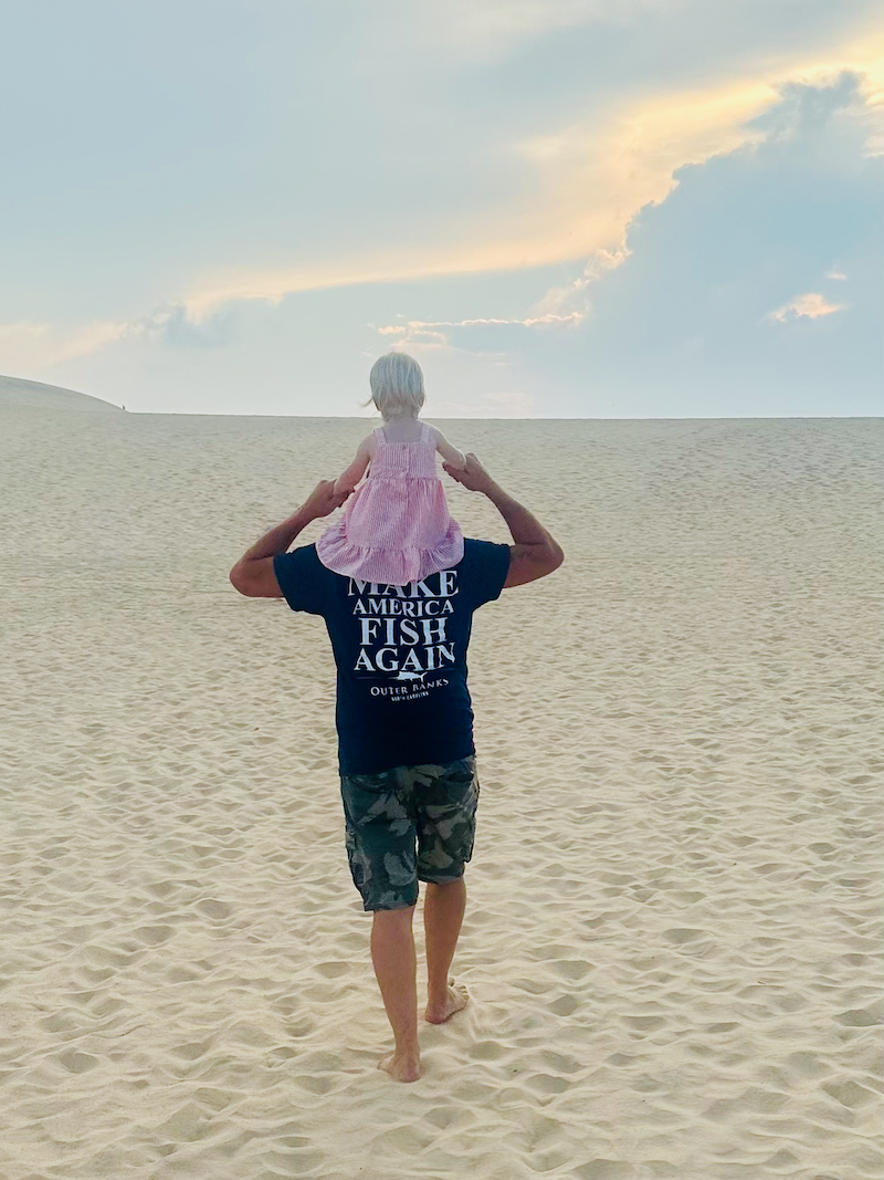 Grandpa with toddler girl on his shoulders
