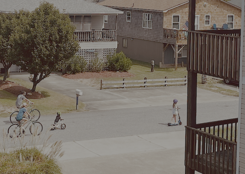 Family riding bikes and scooter