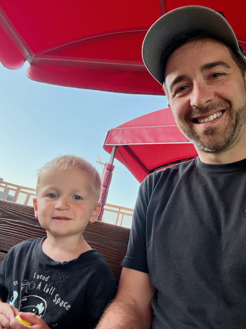 Dad and son on train ride at Professor Hacker's Lost Treasure Mini Golf