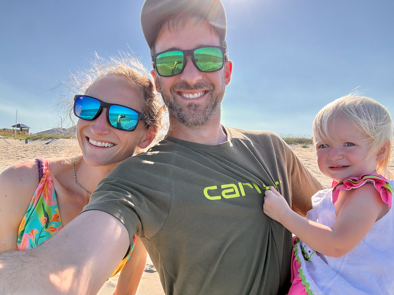 Mom and dad on beach with toddler girl