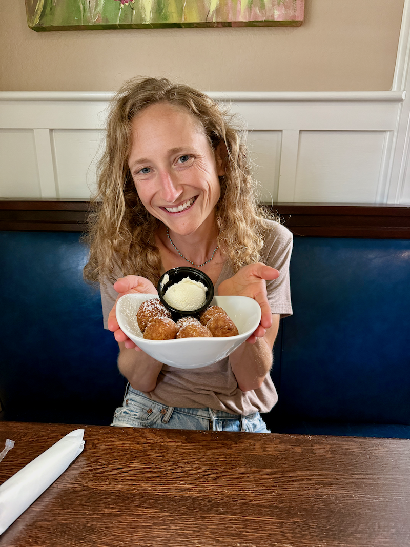 Girl holding hush puppies at Miller's Seafood in Outer Banks, NC