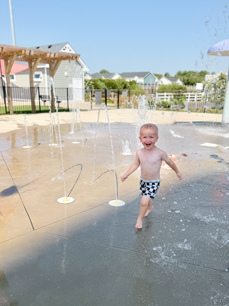 Toddler boy at splash pad