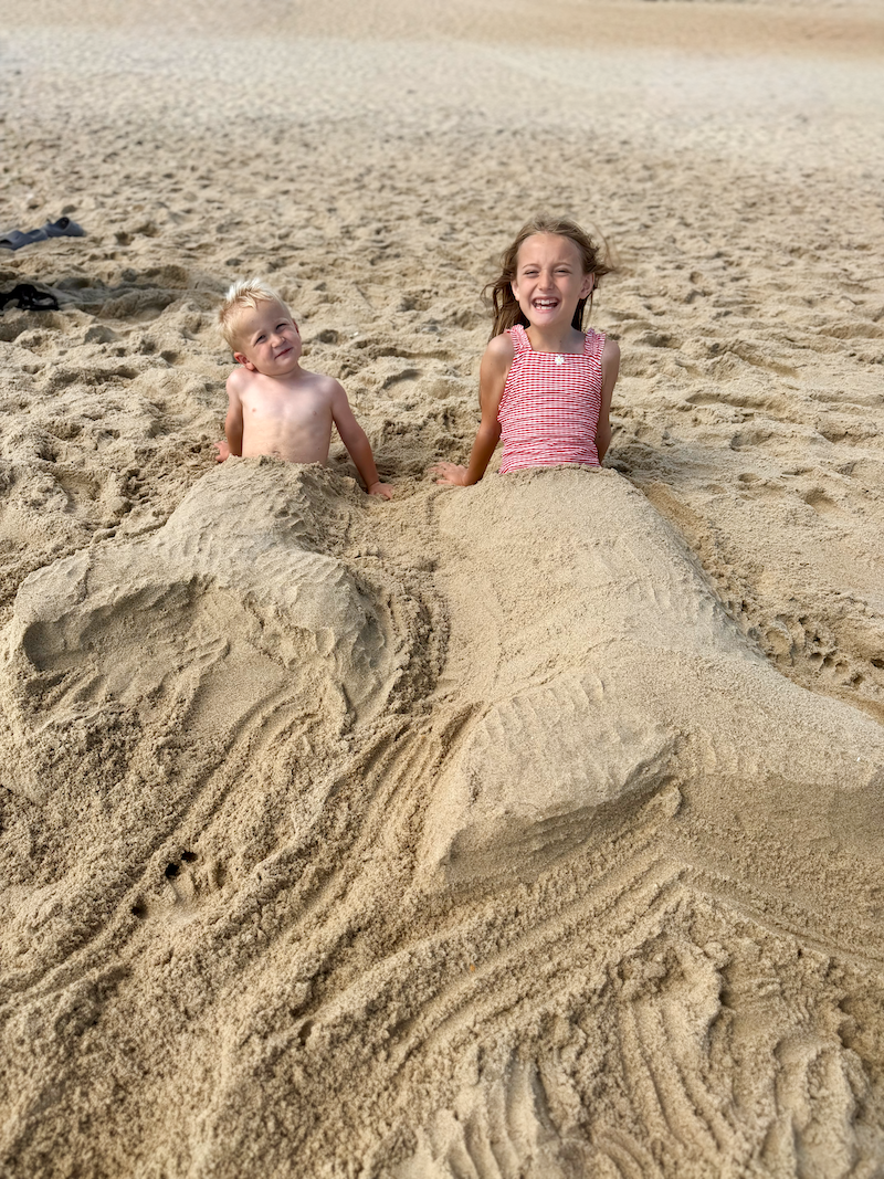 Kids burned in sand as mermaids
