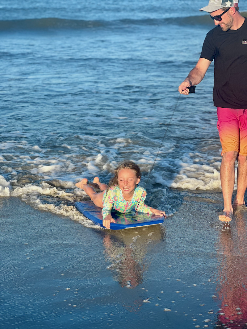 Girl in the ocean on a boogie board