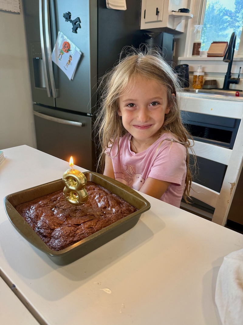 Girl with brownies and 8 candle